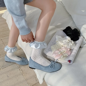 Sweet cream-colored ruffled socks set with delicate lace patterns and satin trims