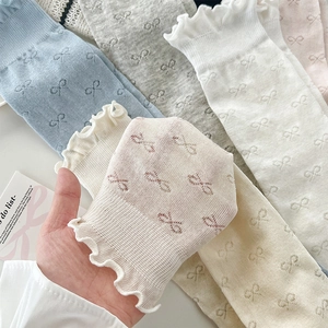 Close-up of bow jacquard pattern and lettuce trim cuff on breathable summer socks