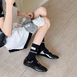 Vue détaillée de chaussures Mary Jane en cuir verni noir avec chaussettes à bordure dentelle