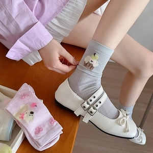 Detail of breathable mesh socks with cute cartoon embroidery and pastel purple finish