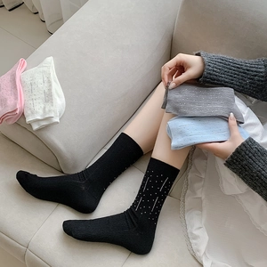 Five pairs of ribbed cotton socks with sparkling rhinestones in black, grey, and pastel colors