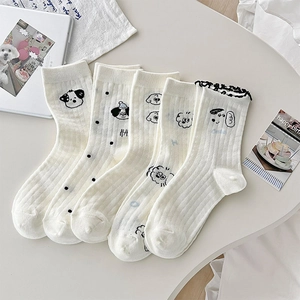 Flat lay of five pairs of cream cotton mid-calf socks with cute cartoon puppy prints