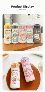 Close-up of 304 stainless steel cartoon water bottles with 3D silicone charms and leakproof lids