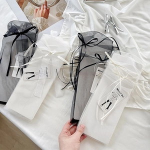 Details von süßen Schleifensocken in Netz-Geschenkverpackung mit Markenanhängern