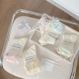 Lot de cinq chaussettes crème avec volants à carreaux pastel et rubans décoratifs
