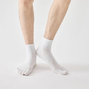 Detail of white five-toe athletic socks featuring ribbed cuffs and split toe design