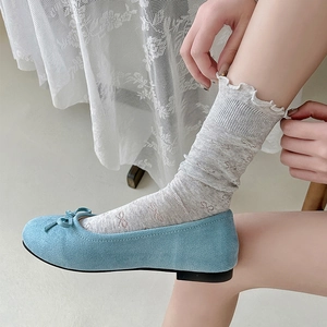 Light blue ballet flats with bow and white ruffle lace socks shown on model