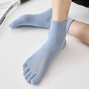 Detail of light blue five-toe athletic socks with ribbed texture and toe separation