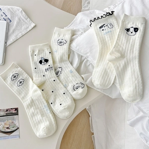 Detailed view of white cotton mid-calf socks with cute cartoon puppy embroidery