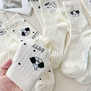 Close-up of white breathable mesh socks with cartoon dog pattern and Happy text