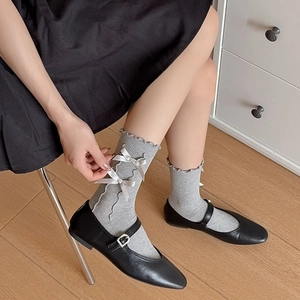 Japanese style gray ruffle socks with white bows and black Mary Jane shoes for women