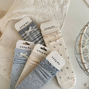 Detailed set of five vintage style socks with bow accents and floral patterns