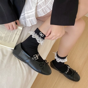 Black JK mid-calf socks with white lace trim, pearl bows, and Mary Jane shoes