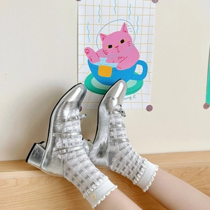 Detail of white lattice texture socks paired with silver metallic Mary Jane heels