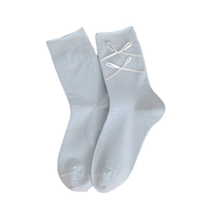Cute light blue mid-tube socks with white ribbon bows and ruffled edges for women
