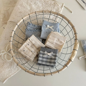 Detailed set of five vintage socks featuring lace ruffles and floral embroidery in a basket