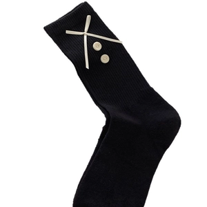 Sweet black mid-calf socks featuring a cream ribbon bow and yellow button accents