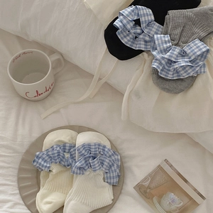 Detail of sweet Japanese style ribbed socks with blue checkered ruffle trim in black, grey, white