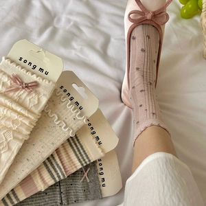 Détail de chaussettes assorties avec bordures en dentelle et motifs en tricot à pois