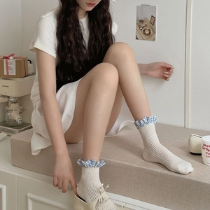 Detail of white ribbed knit socks with blue checkered ruffle trim in sweet Japanese style