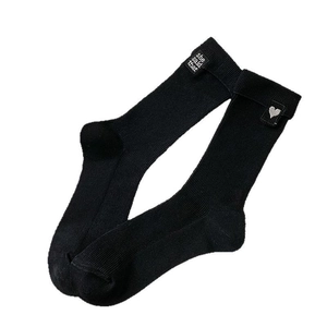 Black mid-calf ribbed knit socks with heart embroidery and letter tag details