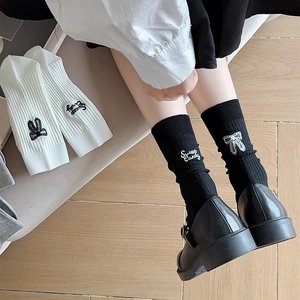 Detail of ballet style knit socks with Sweet Candy lettering and bow embroidery