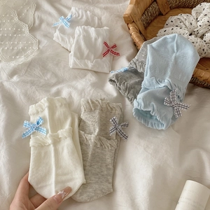 Detail of sweet JK style socks featuring layered ruffle cuffs and plaid bow accents