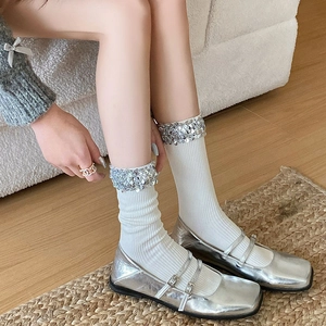 Chic white ribbed mid-calf socks with sequin trim and silver metallic Mary Jane shoes