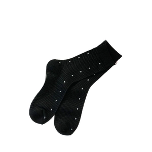 Breathable black polka dot mid-calf mesh socks for women in stylish L-shaped flat lay