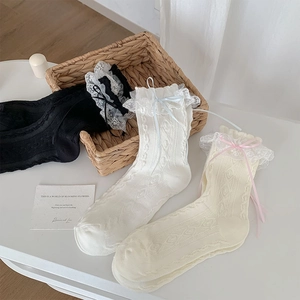 Detailed view of Lolita style socks with lace ruffles, ribbons, and argyle knit patterns