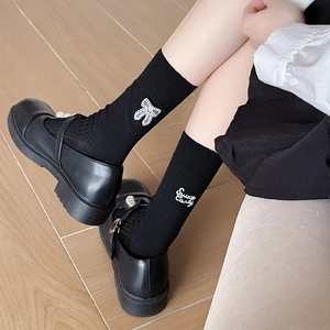 Detail of ballet style cotton socks with sweet candy embroidery and bow design