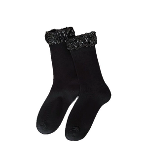 Chic black mid-calf socks with vertical ribs and sparkling sequin trim on the cuff
