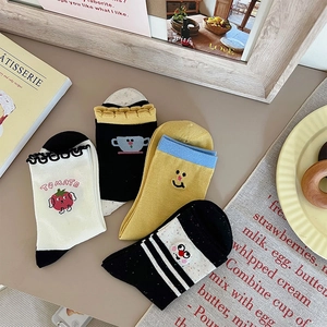 Detail of four pairs of cartoon embroidery socks with ruffles and cute patterns