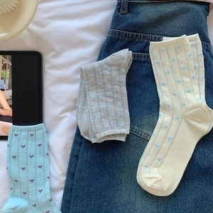 Detail of sweet heart socks set in blue, grey and beige with vertical ribbed textures