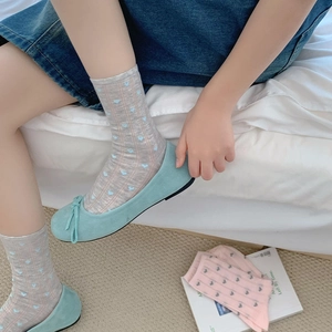 Detail of sweet heart pattern cotton socks paired with light blue bow flat shoes