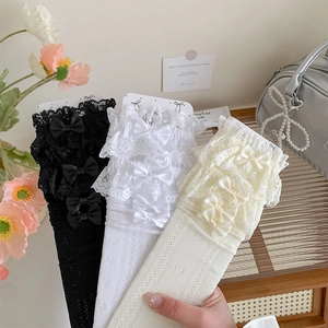Detail of Lolita style lace socks with heart patterns and bows in three colors