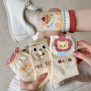 Detail of sweet cotton socks featuring cute bear patterns and wavy lettuce trim edges