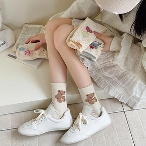 Off-white cotton socks with cute brown bear patterns and rib knit cuffs
