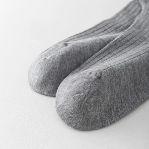 Macro shot of seamless toe stitching on heather grey ribbed knit cotton blend socks