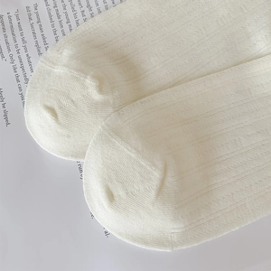 Close-up of white vertical stripe hollow mesh knit on breathable cotton crew socks