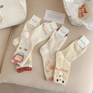 Detailed view of ruffle cuff cotton socks with cute bear and flower embroidery patterns