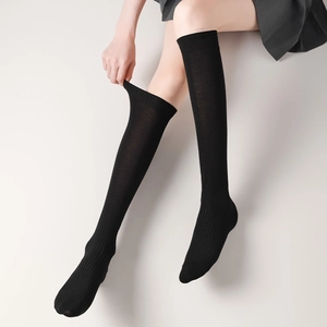 Detail of black calf socks showing the ribbed texture and high elastic stretch fabric