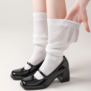 Sheer white calf-high socks made of thin breathable nylon paired with Mary Jane shoes