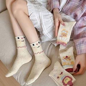 Detail of knit cotton socks with cute cartoon bear pattern and ruffled lettuce edges