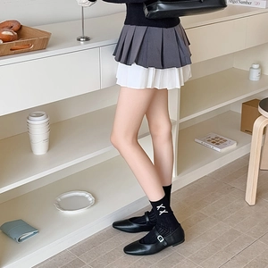 Detail view of Japanese ballet style bow socks paired with black Mary Jane leather shoes