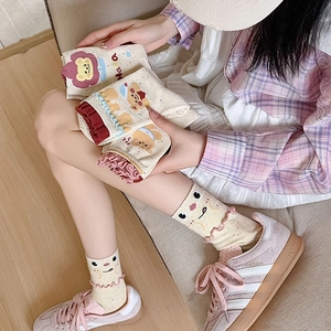 Detail view of cotton crew socks with bear patterns and pink ruffled lettuce edge cuffs
