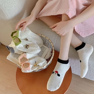 Detail of cute low-cut ankle socks with polka dots and animal embroidery in various colors