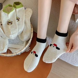 Detail of cute cartoon cotton socks featuring colorful flecked yarn and ribbed cuffs