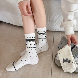 Detailed knit mid-calf socks with cute dog patterns and black heart accents on legs