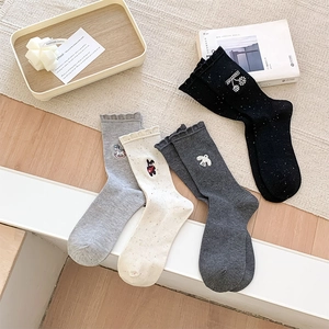 Detail view of 4-pair set women's socks with cute embroidery and ruffled lace edge cuffs